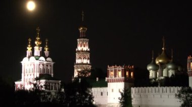 Gece Moskova 'da Novodevichy Manastırı' nın kuleleri, kubbeleri ve beyaz taş duvarları.