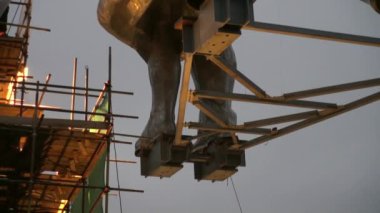 İnşaat alanında inşaat işçileri metal iskelelerde çalışıyor..