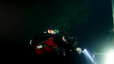 Budapeşte sualtı mağarasında kırmızı yüzgeçli teknik dalgıç.