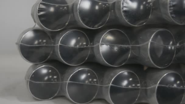 Stainless steel pipes in polyethylene packaging. — Stock Video