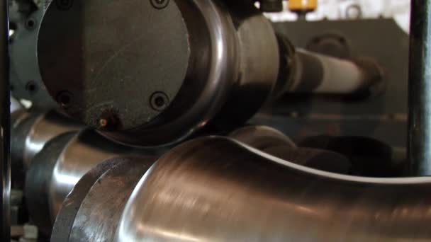 Close-up of metal-rolling machines for production metal steel pipes in factory. — Stock Video