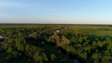 Bataklık nehrinin insansız hava aracı videosu büyüleyici manzaralı yeşil otlaklarla çevrili. Açık hava iklimi kavramı.