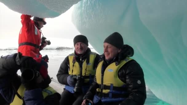 People near Ice floe and iceberg in ocean of Antarctica. — Stock Video