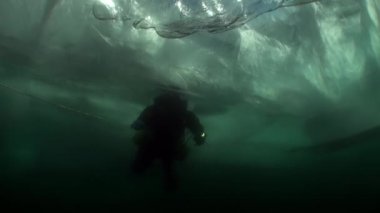 Baykal Gölü 'nün soğuk suyunda buzun altında dalgıç..