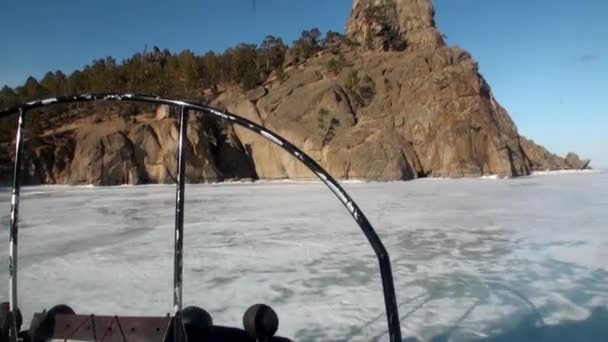 Airboat planeador de aire se mueve a la costa de montaña en el hielo del lago Baikal. — Vídeos de Stock