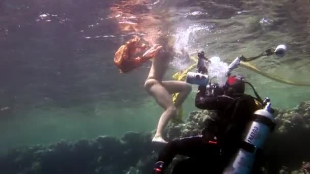 Camarógrafo dispara video joven mujer bajo el agua modelo. — Vídeos de Stock