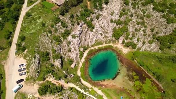 An overhead shot of a beautiful turquoise lake in a field. — Stock Video