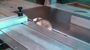 Woodworking machine  with a circular saw saws veneer angle. Two circular saws of woodworking machine.