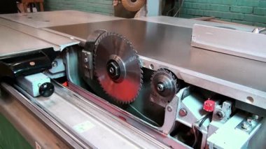Woodworking machine  with a circular saw saws veneer angle. Two circular saws of woodworking machine.