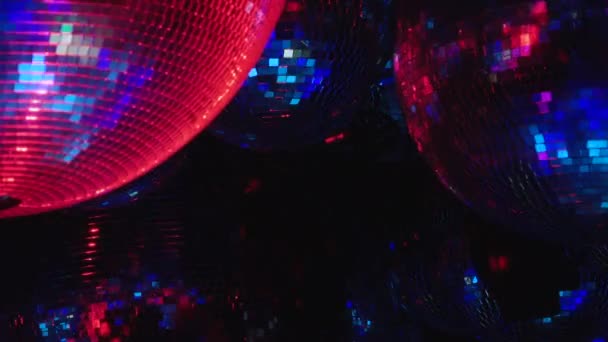 Mirror balls reflect rays of colored lights. — Stock Video