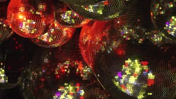 Mirror balls reflect rays of colored lights. — Stock Video