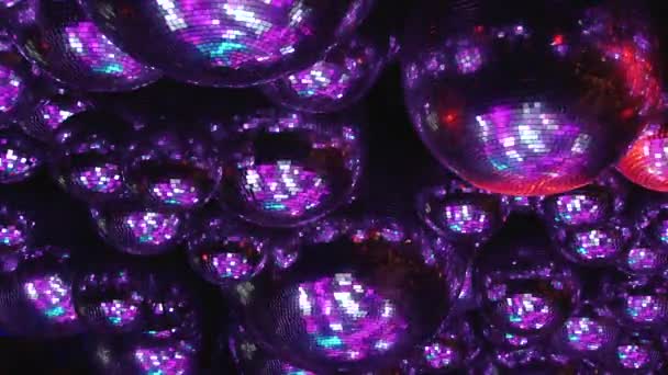 Mirror balls reflect rays of colored lights. — Stock Video