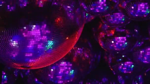 Mirror balls reflect rays of colored lights. — Stock Video