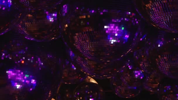 Mirror balls reflect rays of colored lights. — Stock Video