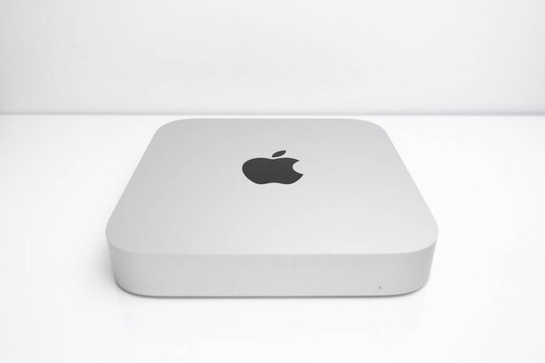 Apple Mac Mini computer on a white desk.