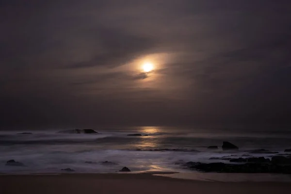 Moonlight reflected on ocean at night. Long exposure.