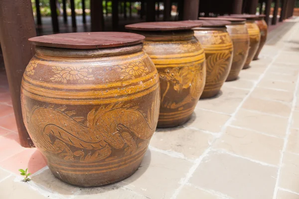 Fila de tarro de agua con patrón de dragón y tapa de madera — Foto de Stock