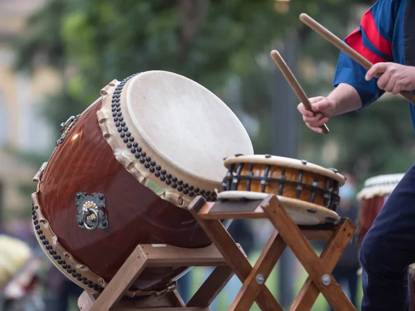 Man Playing Drums of Japanese Musical Tradition during a Public Outdoor Event.