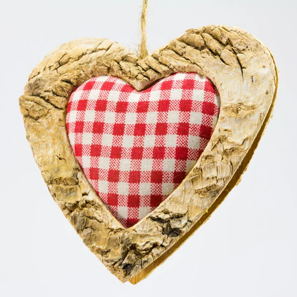 Wooden heart, squared textile in the middle — Stock Photo, Image