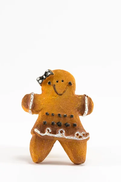 Uma estatueta de biscoito de mulher de Natal com arco e saia — Fotografia de Stock