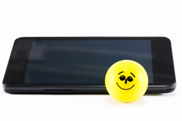 Uśmiechający się piłka odbijając w pobliżu telefonu komórkowego — Zdjęcie stockowe