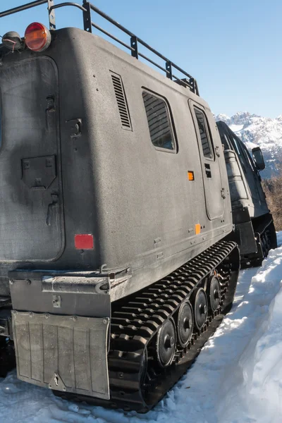Articulated military tracked cargo vehicle on snow — Stock Photo, Image