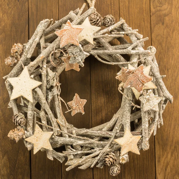 Christmas decoration with twigs, brown pine cone and wooden star — Stock Photo, Image