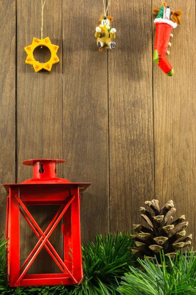 Christmas decoration with red candlestick and brown pine cone on — Stock Photo, Image