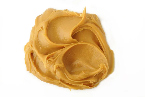 Manteiga de amendoim sobre fundo branco — Fotografia de Stock