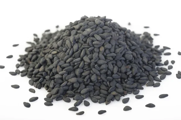 Black sesame seeds on background — Stock Photo, Image