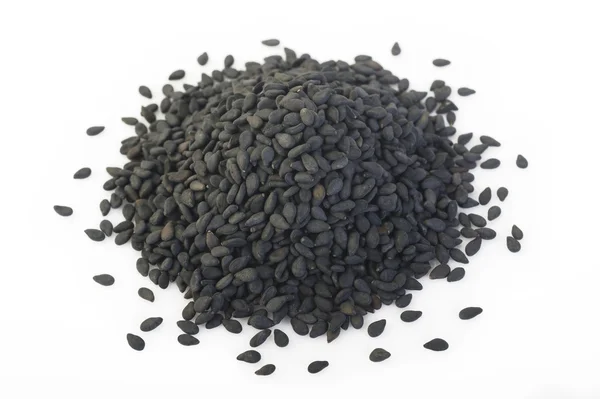 Black sesame seeds on background — Stock Photo, Image