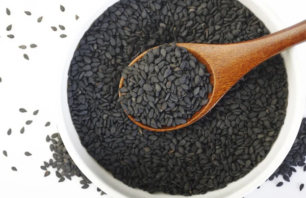 Black sesame seeds in spoon — Stock Photo, Image