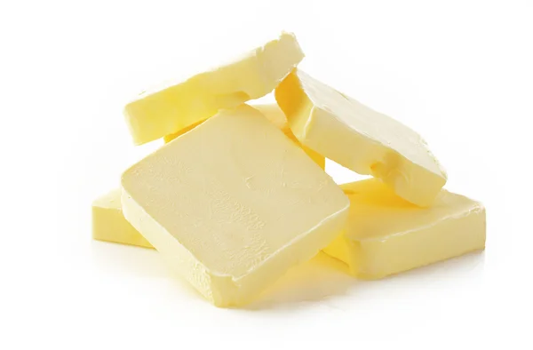 Piece of butter  on  white background Royalty Free Stock Photos