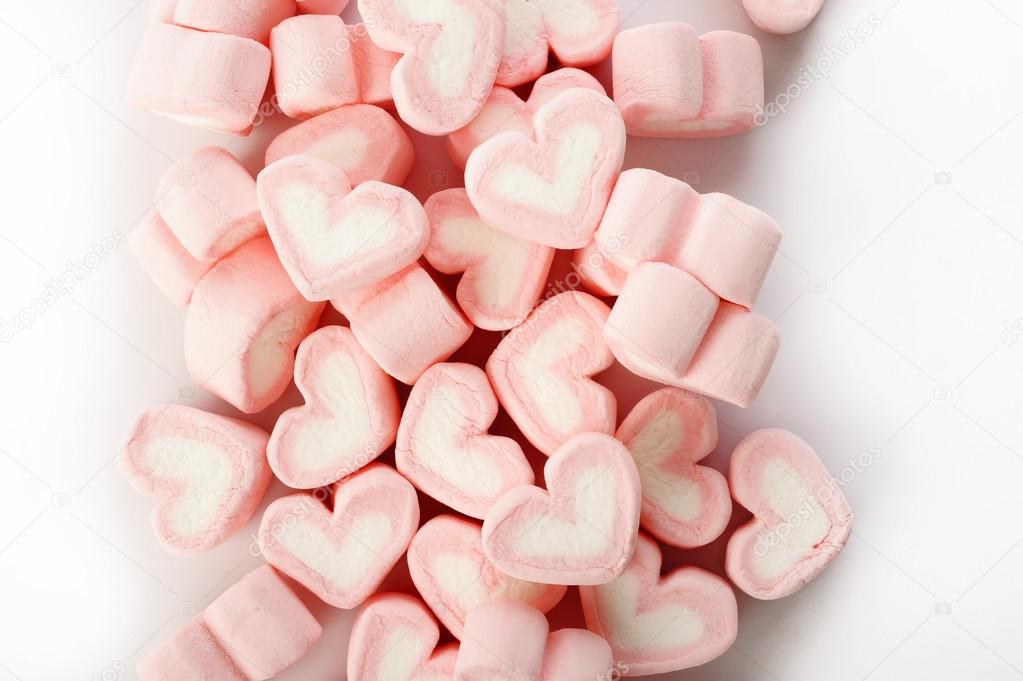 Pink heart shaped marshmallows on white background Stock Photo by