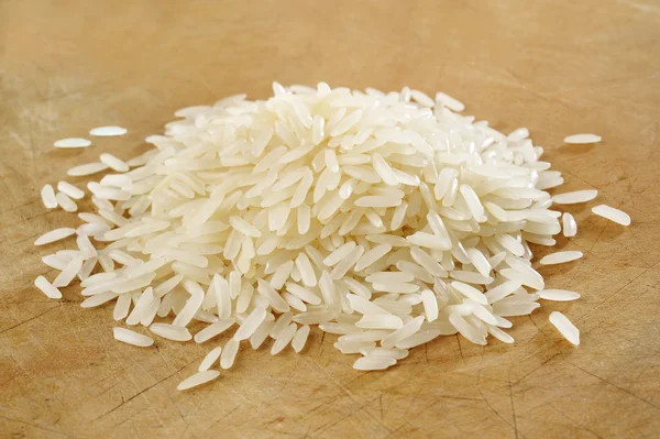 Rice on wood background Stock Picture
