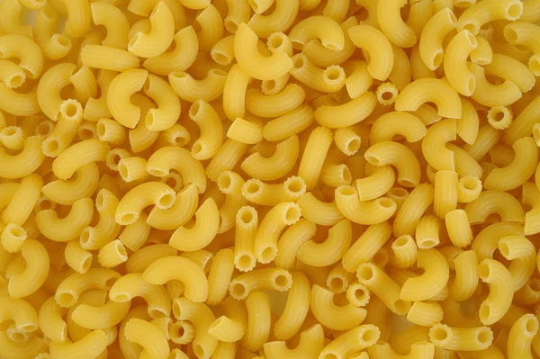 Raw pasta macaroni background — Stock Photo, Image