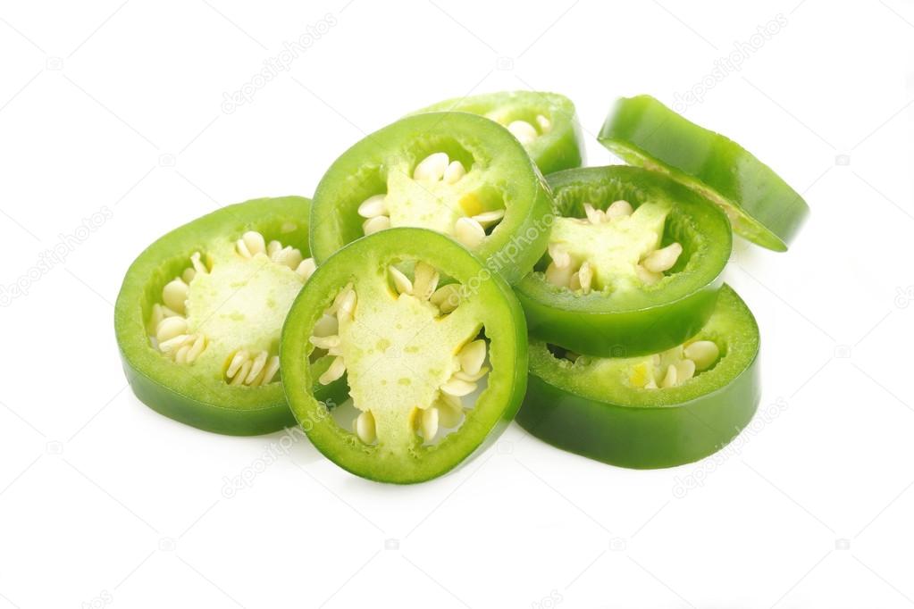 sliced green jalapeno peppers on white
