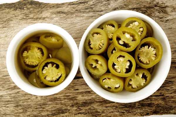 Pickled sliced green jalapeno peppers in white bowl — Stock Photo, Image