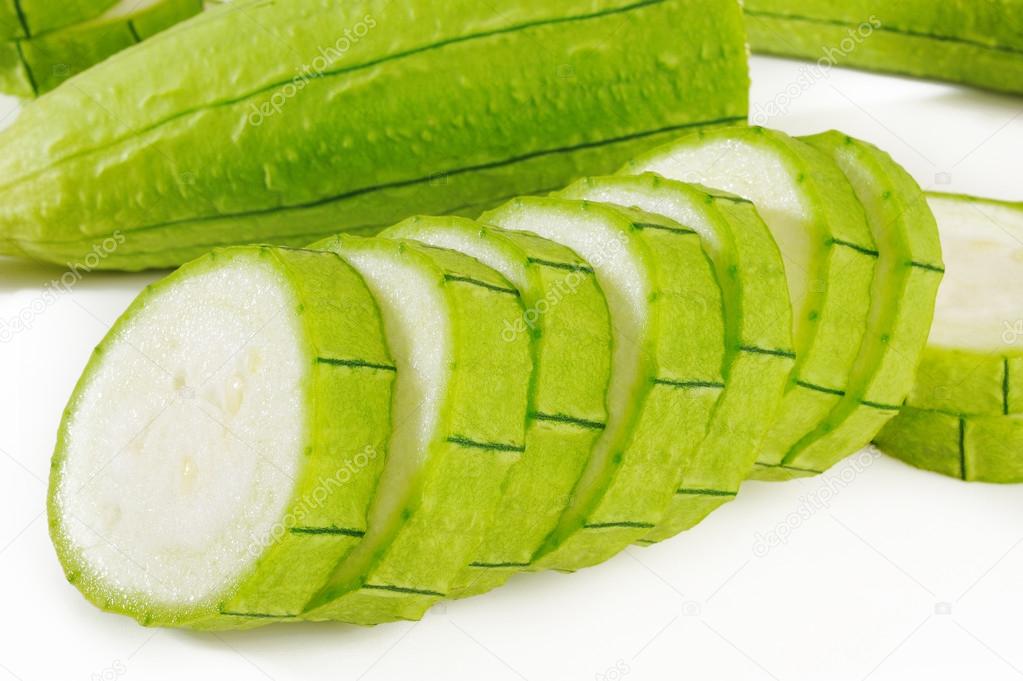 green loofah gourd on white 