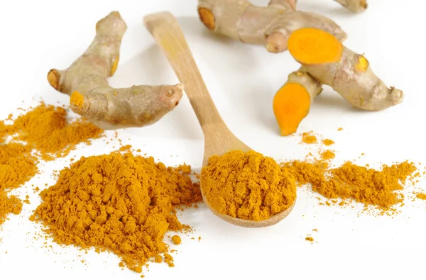 Turmeric powder in wooden spoon — Stock Photo, Image