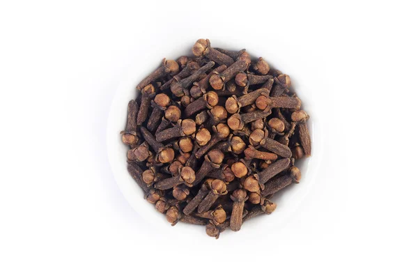 Cloves in white dish on white background — Stock Photo, Image