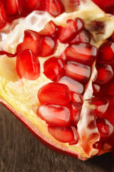 Pomegranate fruits on wooden background — Stock Photo, Image