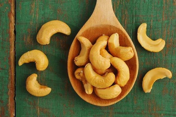 Salted cashews in wooden spoon — Stock Photo, Image