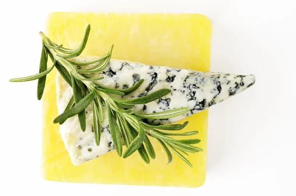 Rosemary on cheese — Stock Photo, Image