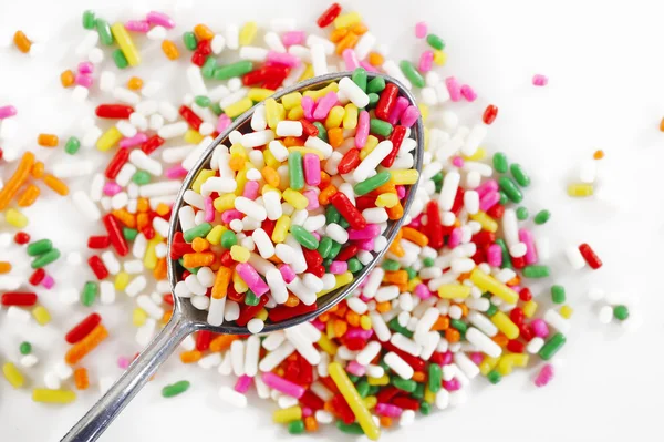 Rainbow sprinkles in spoon — Stock Photo, Image