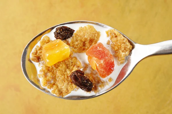 Muesli with milk in spoon — Stock Photo, Image