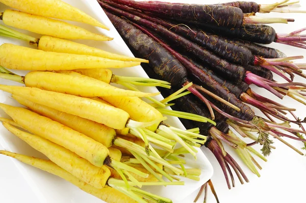 Purple carrots and yellow carrots — Stock Photo, Image