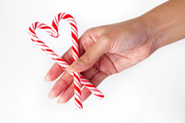 Candy cane heart in hand — Stock Photo, Image