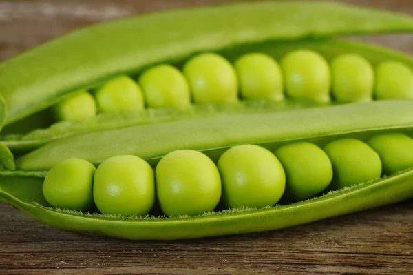 Sugar snap peas on wooden background — Stock Photo, Image