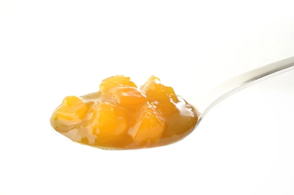 Peach jam in spoon — Stock Photo, Image
